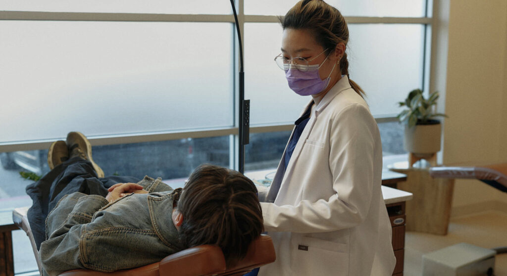 Orthodontist taking care of patient.