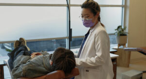 Orthodontist taking care of patient.