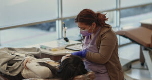 Doctor looking at patient's mouth.